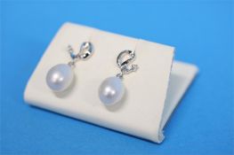 A pair of 9ct white gold diamond and cultured pearl drop earrings.