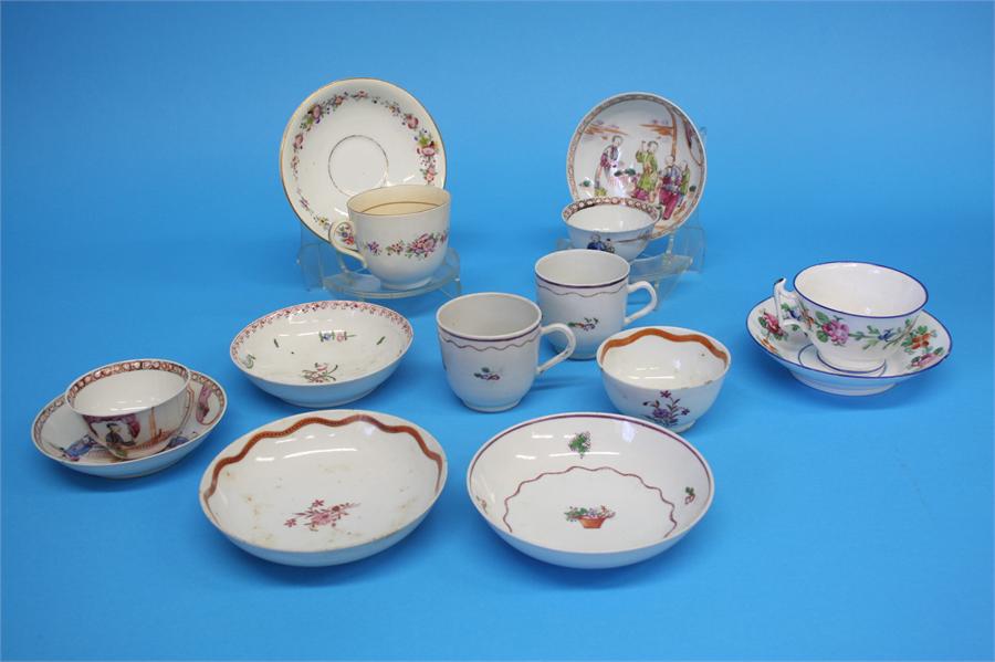 Five tea bowls and saucers and a spare bowl, each decorated with a sprig of flowers, 4 cups and