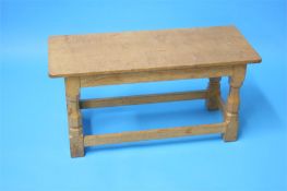 A Robert "Mouseman" Thompson oak coffee table with rectangular top on octagonal carved supports with
