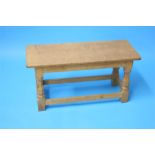 A Robert "Mouseman" Thompson oak coffee table with rectangular top on octagonal carved supports with