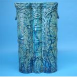 A large Burmantoft's Faience umbrella/stick stand with relief moulded decoration in the oriental