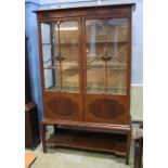 An Edwardian mahogany china cabinet with 2 glazed doors supported on square legs.  114 cm wide