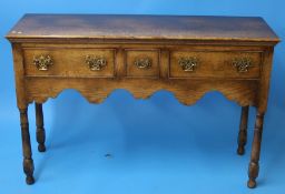 A small oak Titchmarsh and Goodwin oak dresser base with three drawers to the front supported on