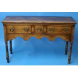 A small oak Titchmarsh and Goodwin oak dresser base with three drawers to the front supported on