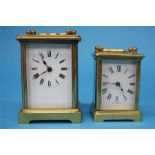A brass carriage clock with white enamelled dial and another small carriage clock.  11 cm high and