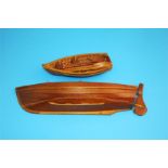 A scratch built wooden cobble and a small rowing boat with two pairs of oars. (2)  32 cm long and 17