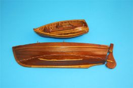 A scratch built wooden cobble and a small rowing boat with two pairs of oars. (2)  32 cm long and 17