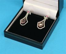 A pair of 18ct white gold clip earrings set with pink tourmaline, diamond and sapphire; stamped