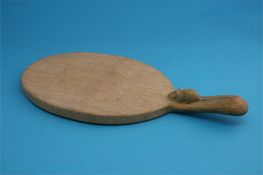 A Robert "Mouseman" Thompson oak oval cheeseboard with carved mouse.  36 cm wide