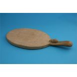 A Robert "Mouseman" Thompson oak oval cheeseboard with carved mouse.  36 cm wide