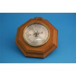 A Robert Mouseman Thompson of Kilburn octagonal barometer and a carved ashtray.