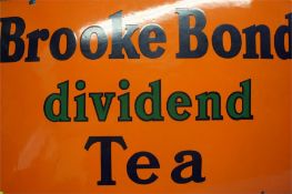 A "Brooke Bond Dividend Tea" enamelled sign on an orange background.  76 cm wide  51 cm high