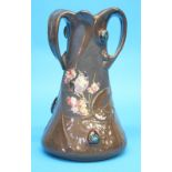 A Bretby Art Nouveau vase with moulded strapwork decoration in faux copper and cabachon style