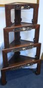 A set of four Oriental hardwood stacking graduated corner tables, each with a pierced freize with