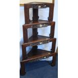 A set of four Oriental hardwood stacking graduated corner tables, each with a pierced freize with