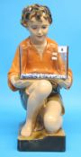A 1930's plaster figure of a young boy kneeling down holding a glass fish tank.  52 cm high
