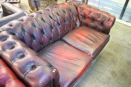 A burgundy leather Chesterfield two seater settee.