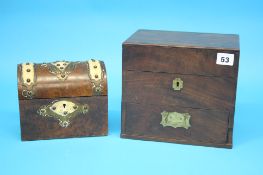 A 19th century mahogany work box with rising lid opening to reveal a fitted interior, below a