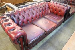 A burgundy leather Chesterfield three seater settee.