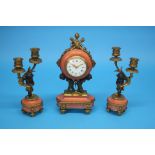 A small French clock garniture, the clock with enamelled circular dial supported by two putti and