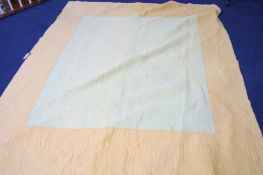 A Durham quilt with central mustard coloured square and green outer border, the reverse with green