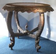 An Oriental hardwood heavily carved oval centre table with pierced fretwork decoration, supported on