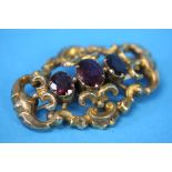 A Victorian gold pierced brooch set with three garnets.  Total weight 7.6 grams