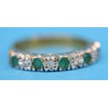 A 9ct gold half hoop eternity ring set with four emeralds and five diamonds.  Ring size N.
