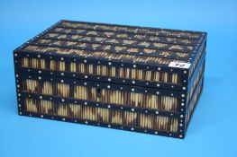 A porcupine quill work box opening to reveal a pull out tray with 9 lidded compartments.  29 cm