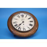 A Smiths Empire oak cased circular wall clock with painted dial.  28 cm diameter.