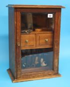 A wall mounted pipe display cabinet, a mahogany pipe/tobacco cabinet and a collection of pipes.