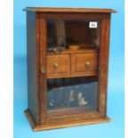 A wall mounted pipe display cabinet, a mahogany pipe/tobacco cabinet and a collection of pipes.