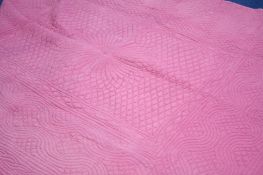 A pink Durham quilt with pale peach reverse.  222 cm x 180 cm.