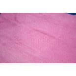 A pink Durham quilt with pale peach reverse.  222 cm x 180 cm.