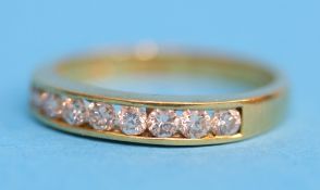 An 18ct gold Channel set ring set with 8 diamonds.  Ring size O.