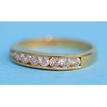 An 18ct gold Channel set ring set with 8 diamonds.  Ring size O.