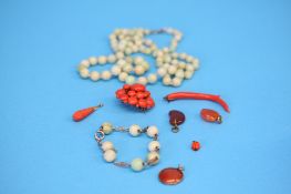 A silver and jade beaded bracelet, a jade necklace and a selection of coral jewellery.