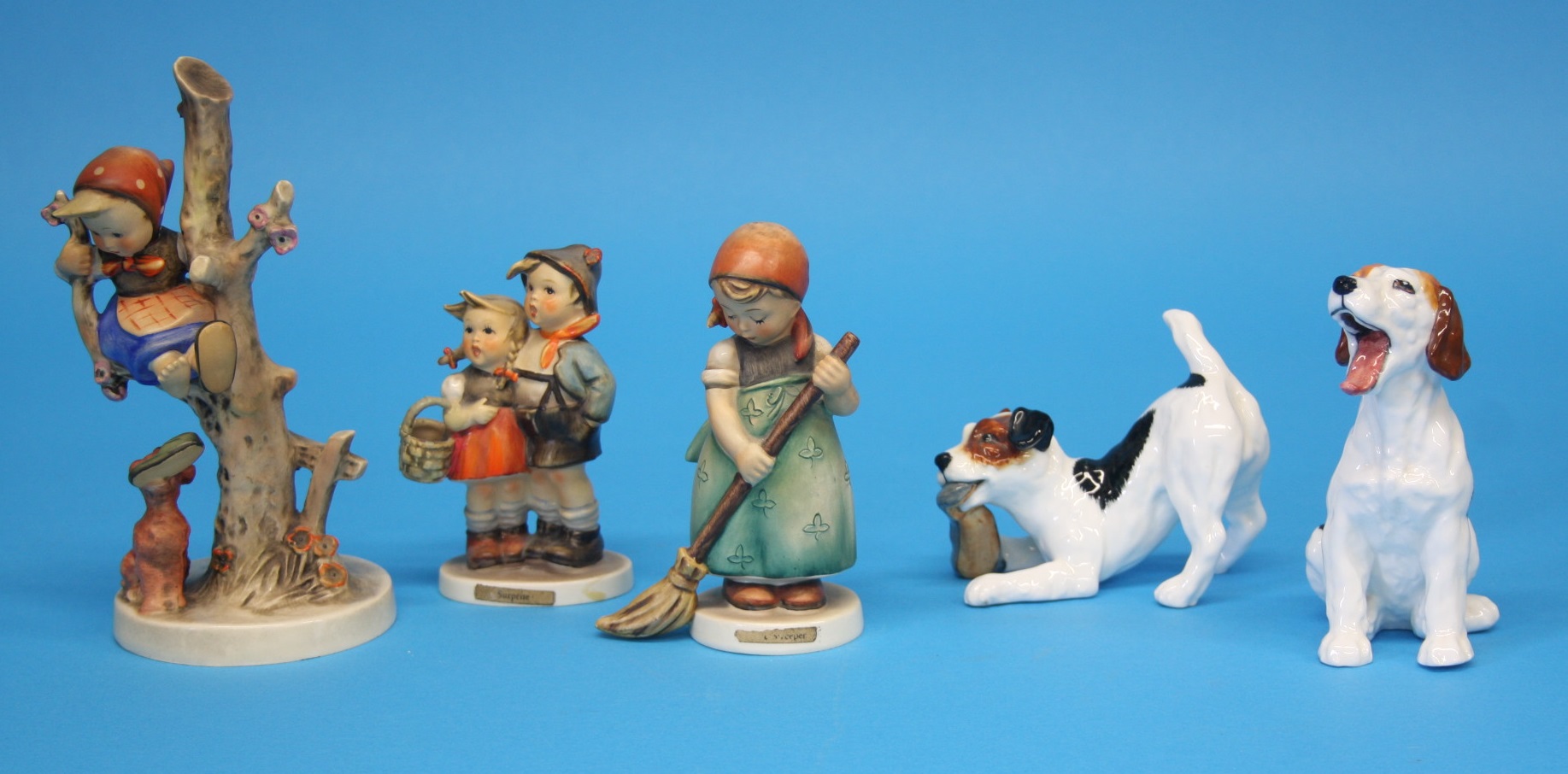 Two Royal Doulton dogs HN1099 and HN2654 and three Hummel figures. (5)