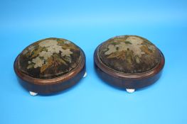 A pair of Victorian mahogany circular foot stools supported on porcelain ball feet.  29 cm