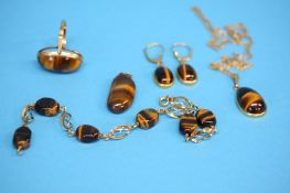 A 9ct gold Tiger's eye ring, a Tiger's eye bracelet, pair of earrings and two pendants.