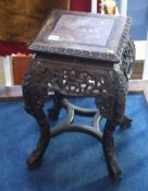 An Oriental hardwood carved and pierced fretwork pedestal with veined inset marble top.  28 cm wide