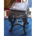 An Oriental hardwood carved and pierced fretwork pedestal with veined inset marble top.  28 cm wide