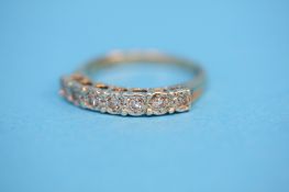 A 9ct gold eternity ring set with seven diamonds.  Ring size Q.