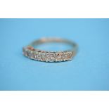 A 9ct gold eternity ring set with seven diamonds.  Ring size Q.