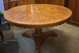 A Victorian mahogany circular centre table with turned central column and trefoil base ending in