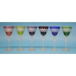 A set of 10 coloured wine glasses.