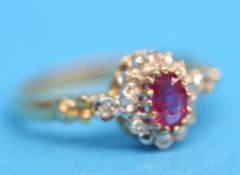A 9ct cluster ring set with central pink sapphire with 12 small diamonds.  Ring size N.
