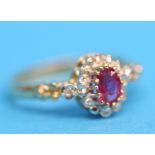 A 9ct cluster ring set with central pink sapphire with 12 small diamonds.  Ring size N.