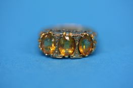 A 9ct gold ring set with three Citrines.  Ring size O.