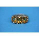 A 9ct gold ring set with three Citrines.  Ring size O.